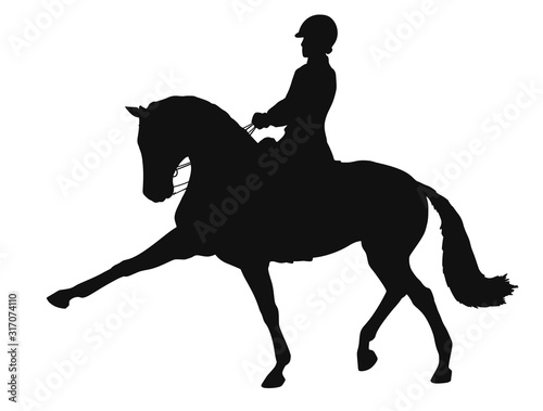 Silhouette of a dressage rider and horse demonstrate an extended trot