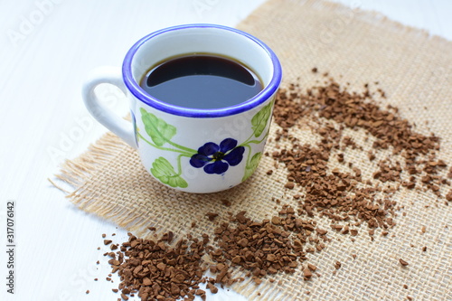  Traditional Colombian coffee cup and coffee beans on wooden background
