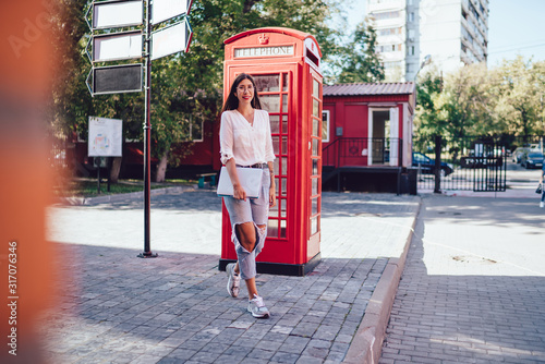 Sticker Full length portrait of positive hipster girl enjoying travel journey in England