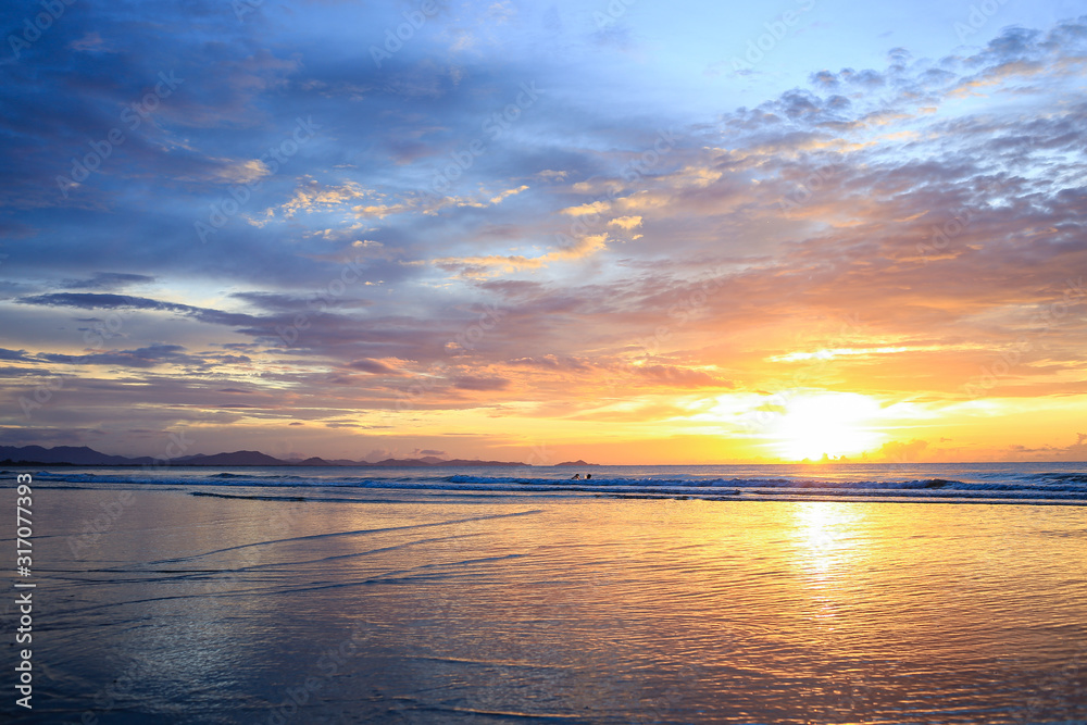 Seascape with a vibrant sunset over a calm sea