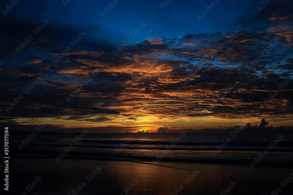 Fototapeta premium Seascape with a vibrant sunset over a calm sea