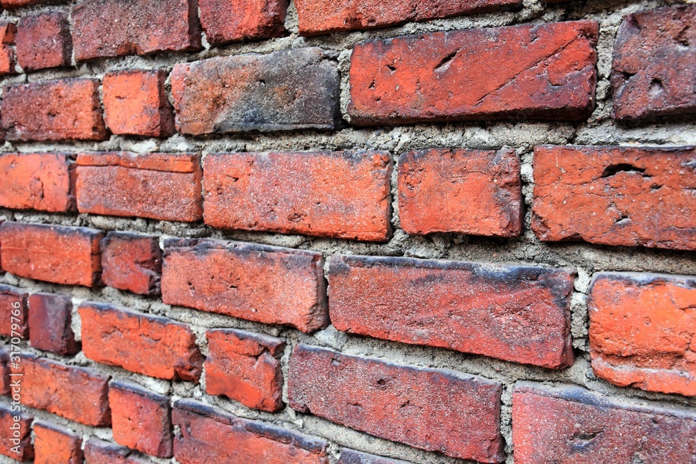 Grunge red brick wall with textured blocks, selective focus. Old stone wall. Red bricks background. Construction works. Brickwork. Grunge red brick wall with textured blocks, selective focus. Old stone wall. Red bricks background. Construction works. Brickwork.