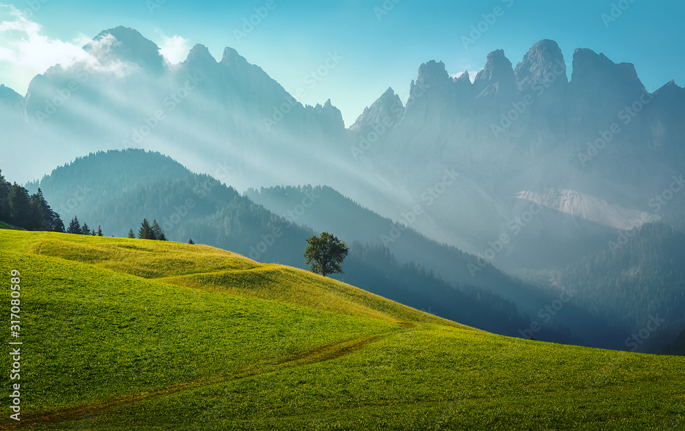 Obraz premium Foggy landscape in the Dolomites mountains. Mountain valley during sunrise. Natural summer landscape. Wonderful nature countryside.
