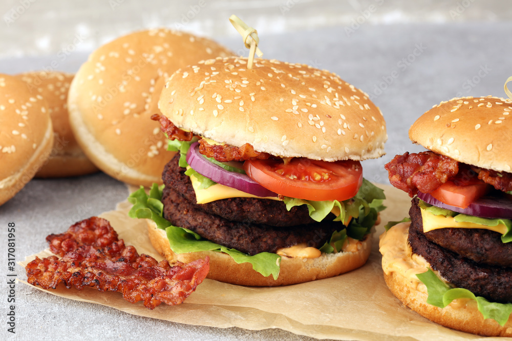 Tasty fresh meat burgers with salad and cheese. Homemade angus burger. Tasty fresh meat burgers with salad and cheese. Homemade angus burger.