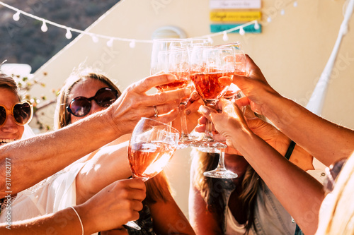 Sticker Group of happy people toasting  together with cups of red wine under the sun lig