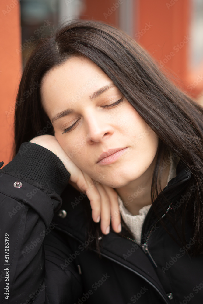 Tired out young woman closing her eyes, intense close-up portrait