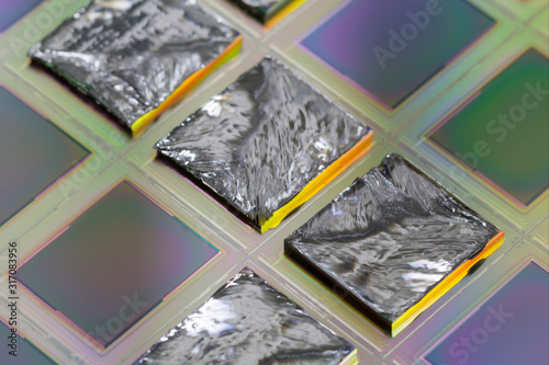 Pieces of polycrystalline silicon integrated on a polysilicon substrate with microchips. photo