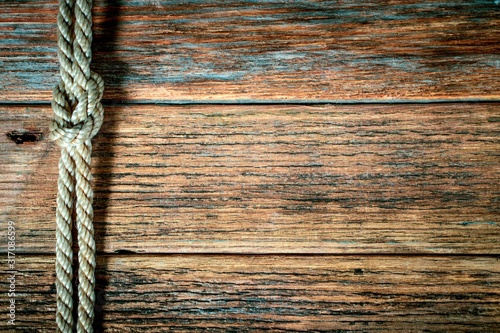 old rope on wooden background