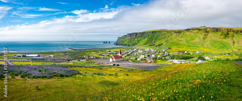 Konstfotografi Panoramic view of basalt stacks Reynisdrangar, black sand beach, church and city
