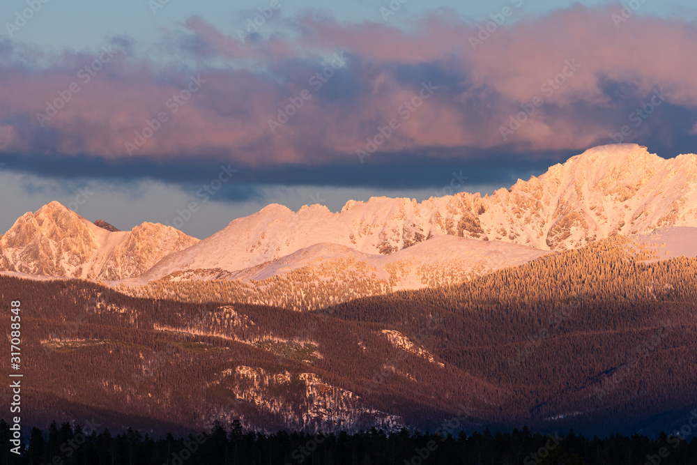 View of Indian Peaks from Fraser Valley Colorado.  The west side of the Indian Peaks at sundown viewed from the Fraser Valley.  The towns of Tabernash and Fraser are below the Indian Peaks.