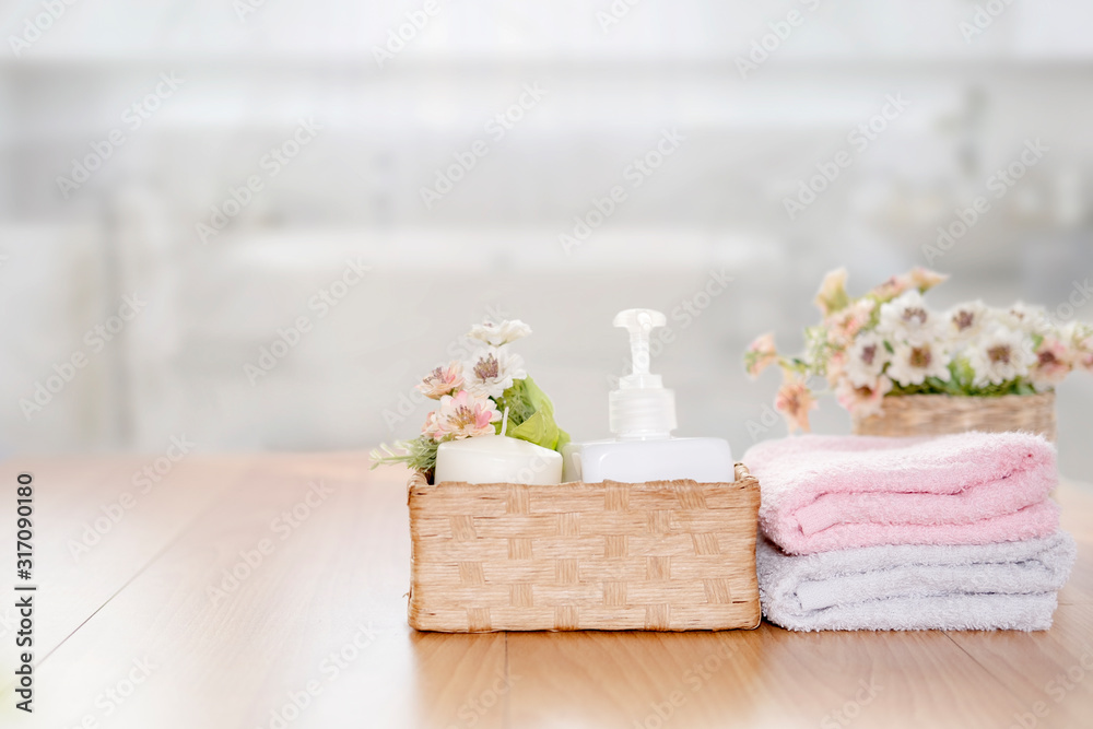 Towels on wooden top table with copy space on blurred bathroom background.