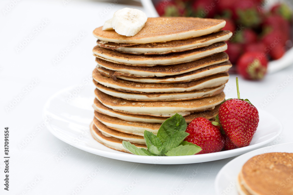 Homemade pancakes with fresh strawberries and honey. Homemade pancakes with fresh strawberries and honey.