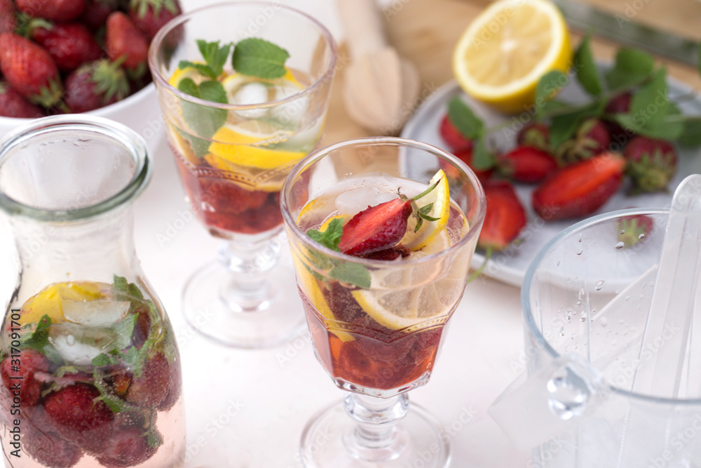 cold strawberry lemonade juice in the glasses with ice cubes cold strawberry lemonade juice in the glasses with ice cubes