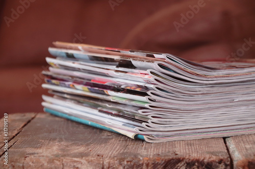 Old magazines on wooden table 