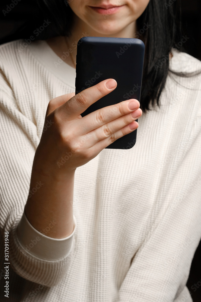 Close-up of a woman using mobile smart phone. Smartphone in female hands Close-up of a woman using mobile smart phone. Smartphone in female hands