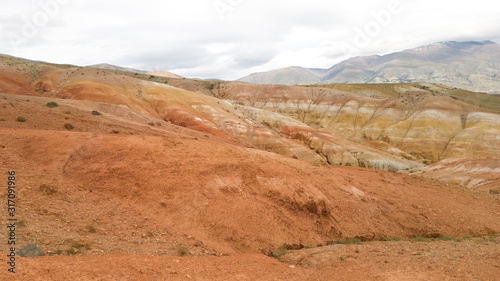Beautiful nature of Altai - bright red mountains Kyzyl-Chin in summer. Panoramic view of the desert and mountain area