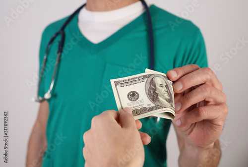 Corruption and bribery in Healthcare and Medicine. Doctor taking money. Health insurance