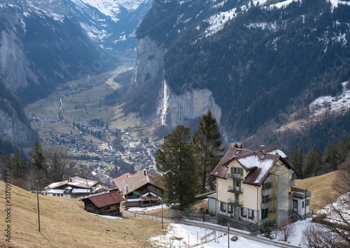View of the Lauterbrunnen Valley from high up above the village of Wengen in the Swiss Alps, photographed on a cold crisp day in winter.