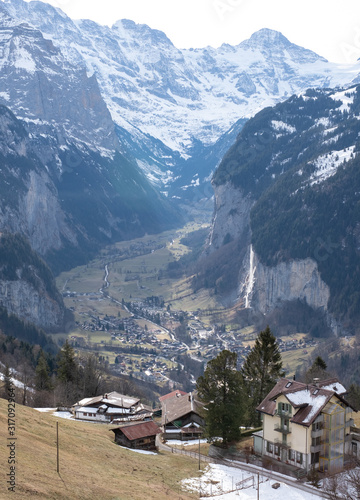 View of the Lauterbrunnen Valley from high up above the village of Wengen in the Swiss Alps, photographed on a cold crisp day in winter.