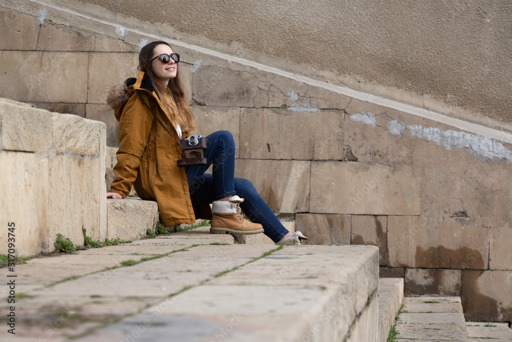 Photo of young tourist girl exploring streets of Baku. Moody photos of teenager girl visiting old city and taking photos of the city Photo of young tourist girl exploring streets of Baku. Moody photos of teenager girl visiting old city and taking photos of the city