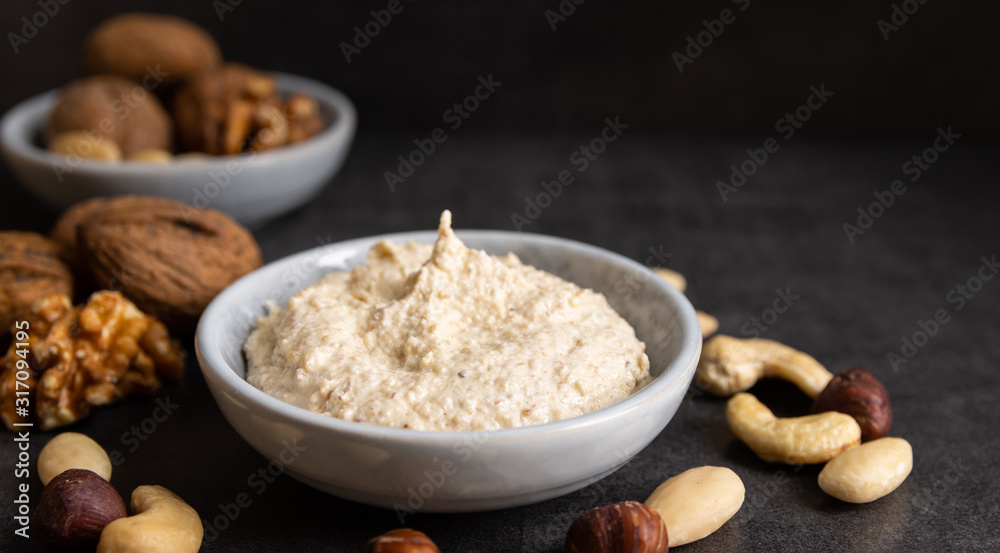 Homemade organic vegan butter made from almonds on a white background. Homemade organic vegan butter made from almonds on a white background.