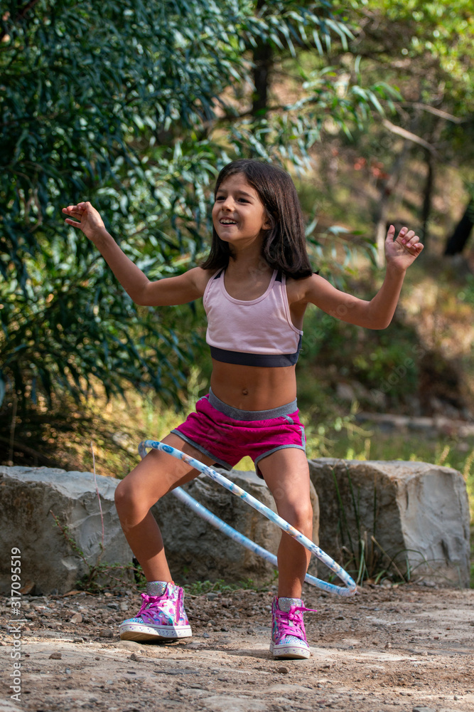 Cute girl posing with hula hoop Cute girl posing with hula hoop