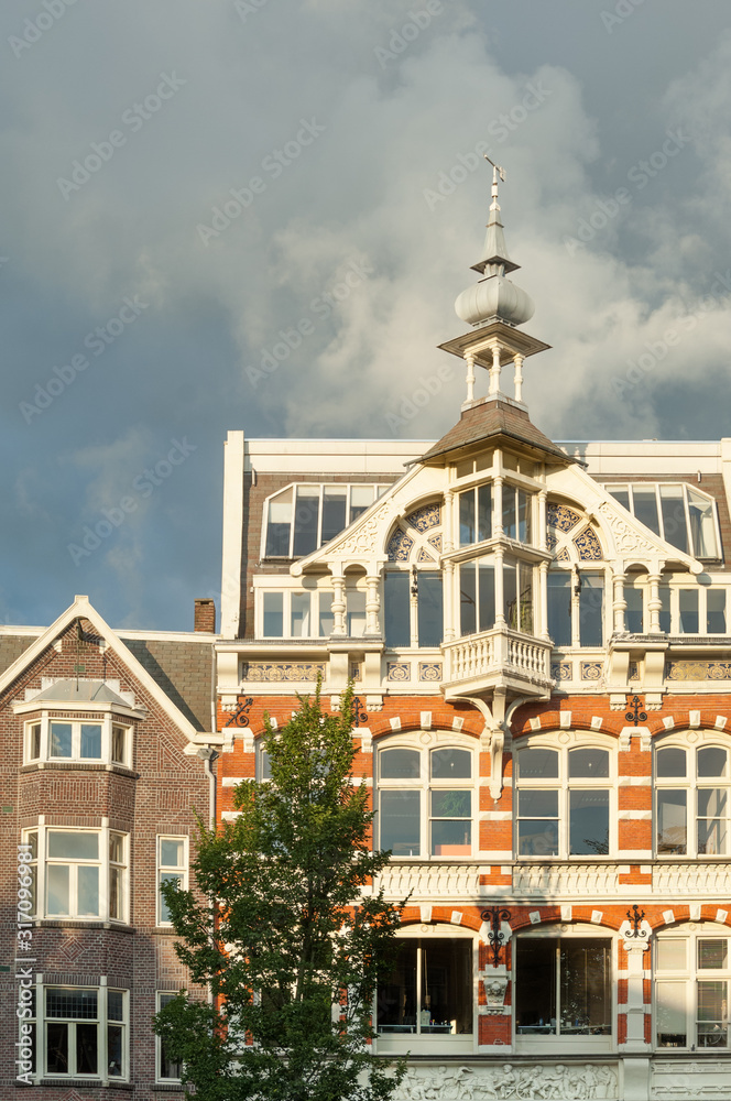 Facades of old traditional merchant houses along Amsterdam canal, the Netherlands
