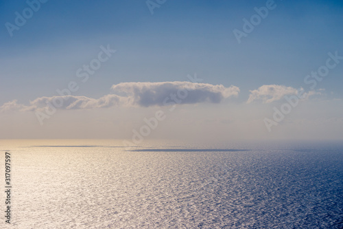 Cloud casting shadow on water surface during sunset with beautiful colors, space for text