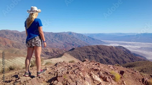 Sexy curvy woman admires the Landscape from the top of Dante's View in Death Valley National Park in California. It is one of the hottest places in the world. Gimbal panning cinematic ProRes 422 4K