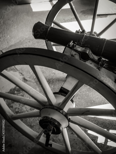 A black and white portrait of an old world cannon