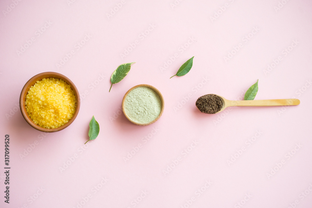 Cosmetic bath salt, grape gomaj for the face, coffee scrub for the body on a pink background. Cosmetic bath salt, grape gomaj for the face, coffee scrub for the body on a pink background.