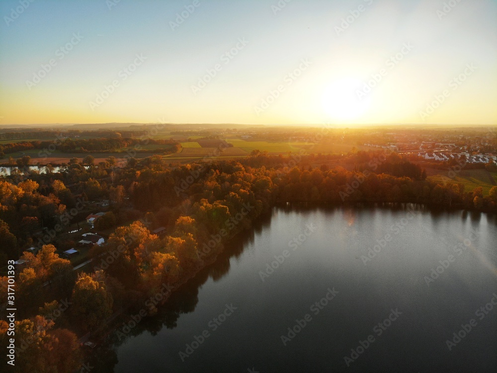 Sunset with a drone from above a lake in autumn 