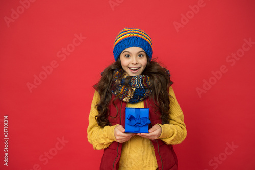 oh my god. girl knitted hat and scarf. ready for christmas. she is going on xmas party. seasonal shopping sales. childhood happiness. winter girl with new year present box. happy winter holidays