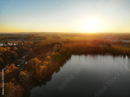Sunset with a drone from above a lake in autumn 