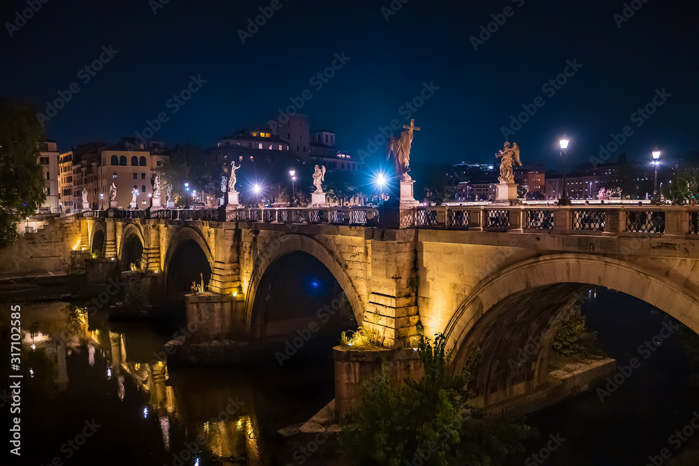 Saint Angelo Bridge over Tiber River in Rome at night, Italy.