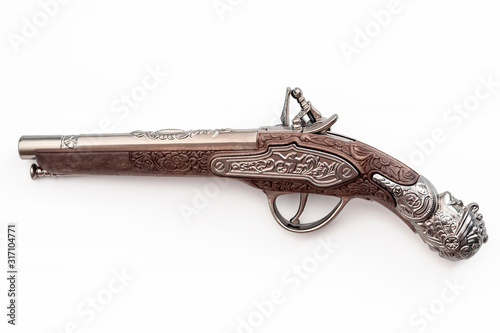 Obraz na płótnie Firearms dating to the american revolution and antique collectables concept with ornate old fashioned dueling flintlock pistol isolated on white background with clipping path cutout w salonie