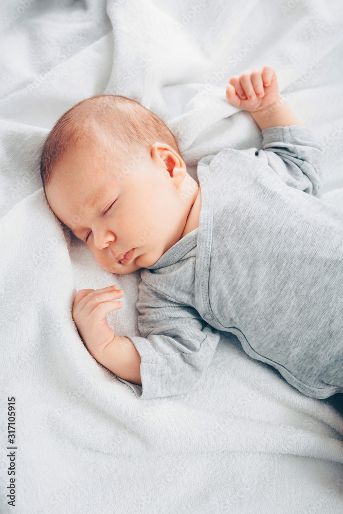 Sleeping newborn baby boy in bed. Sleeping newborn baby boy in bed.