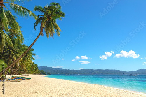 Fototapeta Naklejka Na Ścianę i Meble -  The view of Boracay White beach with coconut palm trees, boats and no people