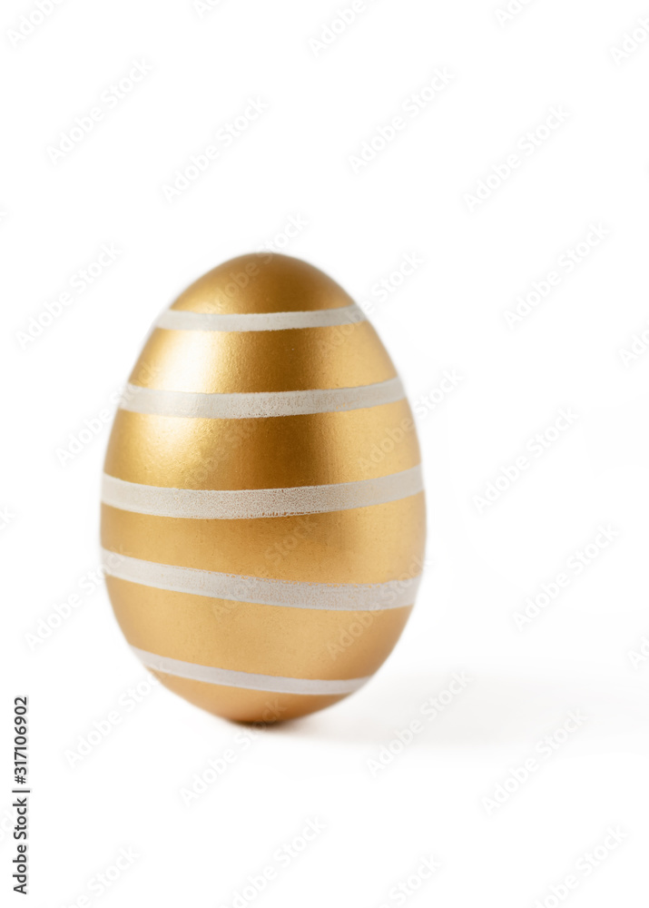 Golden colored easter egg isolated on white background. Happy Easter time. Golden colored easter egg isolated on white background. Happy Easter time.