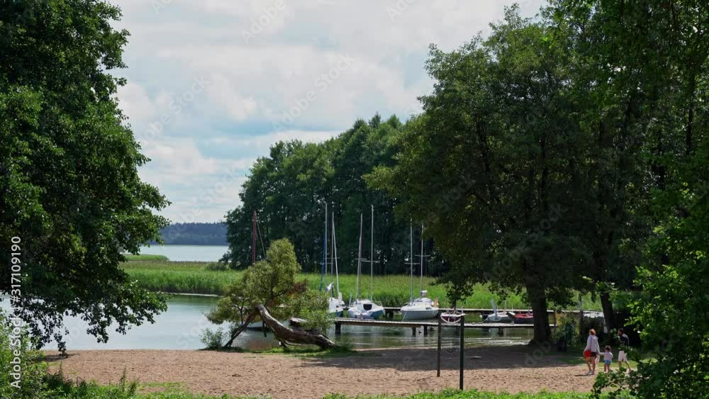 Yacht marina with beach and trees on the shore of the lake. Yacht marina with beach and trees on the shore of the lake.