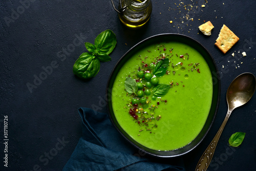 Delicious creamy green pea soup. Top view with copy space. photo