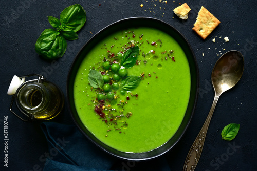 Delicious creamy green pea soup. Top view with copy space. photo