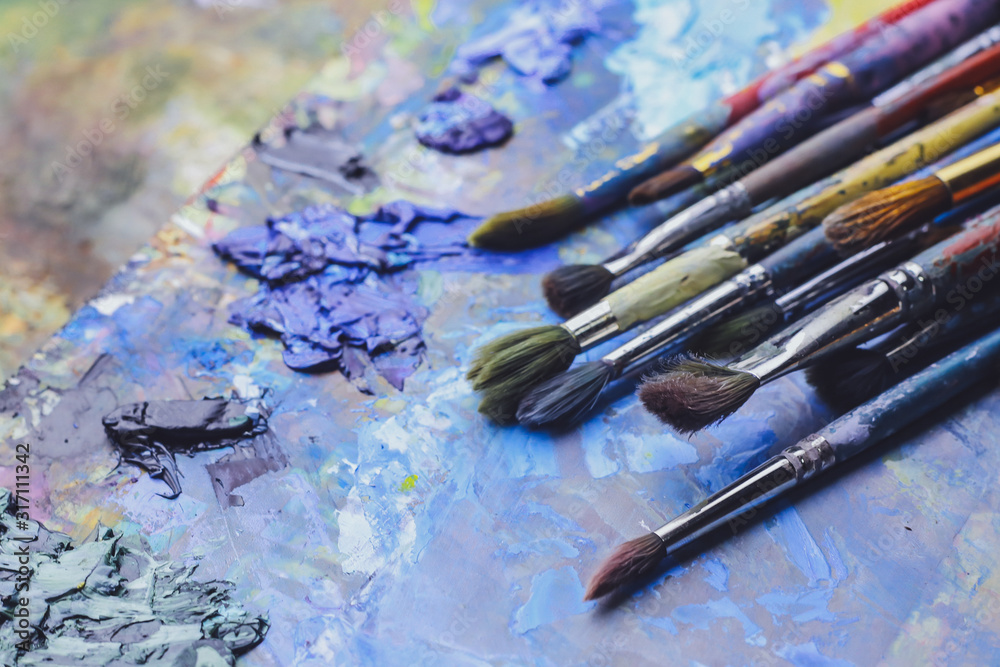 Fototapeta premium Paint brushes on palette, close up