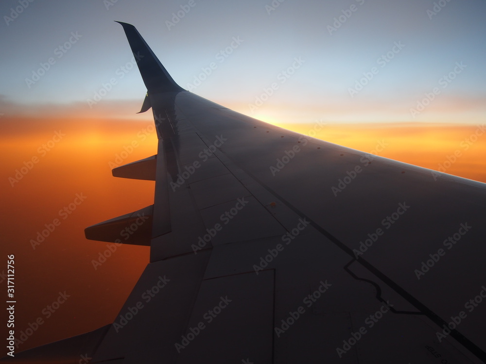 Airplane wing with Sunset Background from Air Airplane wing with Sunset Background from Air