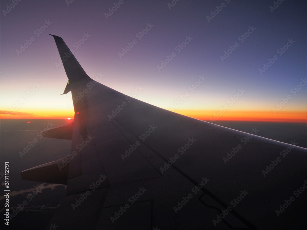 Airplane wing with Sunset Background from Air Airplane wing with Sunset Background from Air