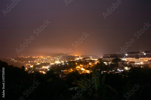 Wallpaper Mural City lights of the historic city centre of Ouro Preto, Brazil, glowing in the rainstorm and reflecting in the clouds lighting up the night sky Torontodigital.ca