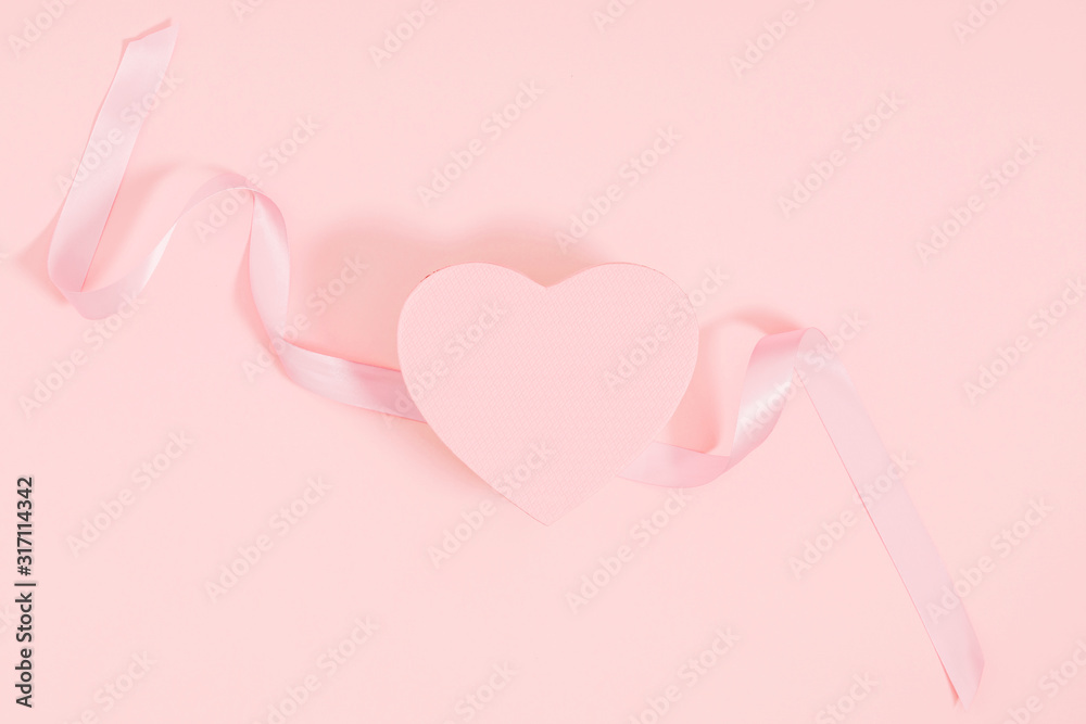 Composition for Valentine's day. Holiday  pink background with gift, white satin bow, ribbon. Valentines Day, Easter, Happy Women's Day, Mother's day. Flat lay, top view, copy space