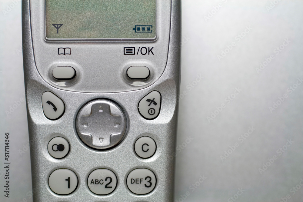 Close up shot of a silver cordless phone Close up shot of a silver cordless phone
