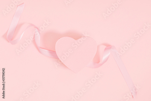 Composition for Valentine's day. Holiday  pink background with gift, white satin bow, ribbon. Valentines Day, Easter, Happy Women's Day, Mother's day. Flat lay, top view, copy space © prime1001