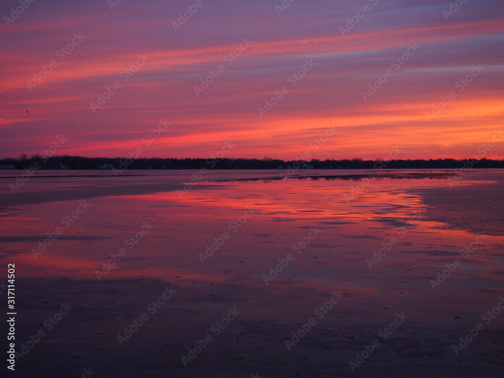 Beautiful Winter Sunset on Ice Covered Lake